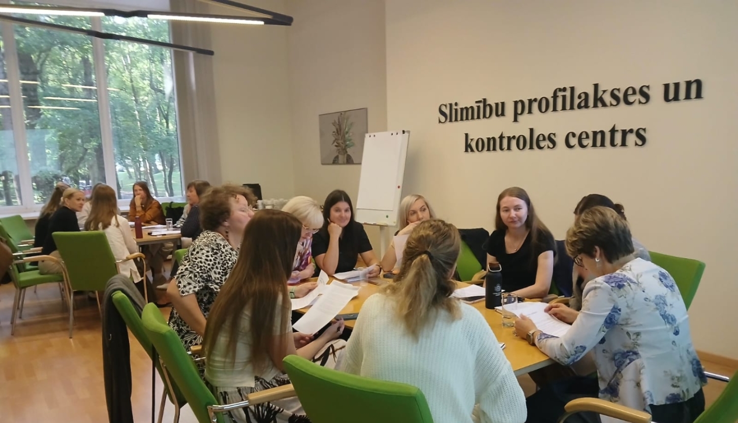Sapulce, cilvēki sēž ap galdu un sarunājas